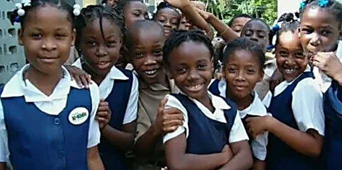 Smiling children in school uniforms from the Goodwill community in Jamaica