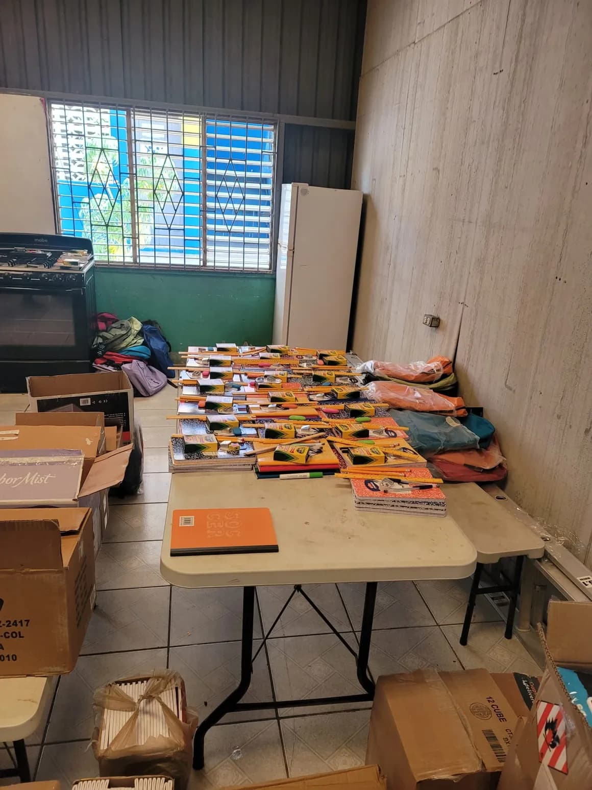 Tables filled with notebooks and school supplies ready for students