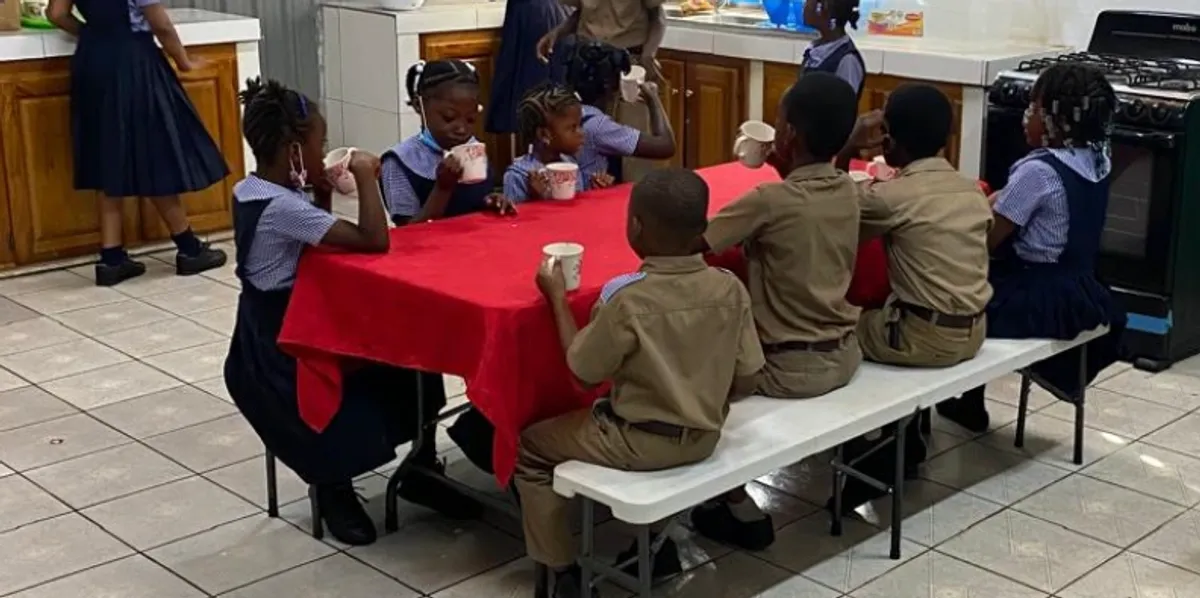 Students drinking from cups during the morning breakfast program
