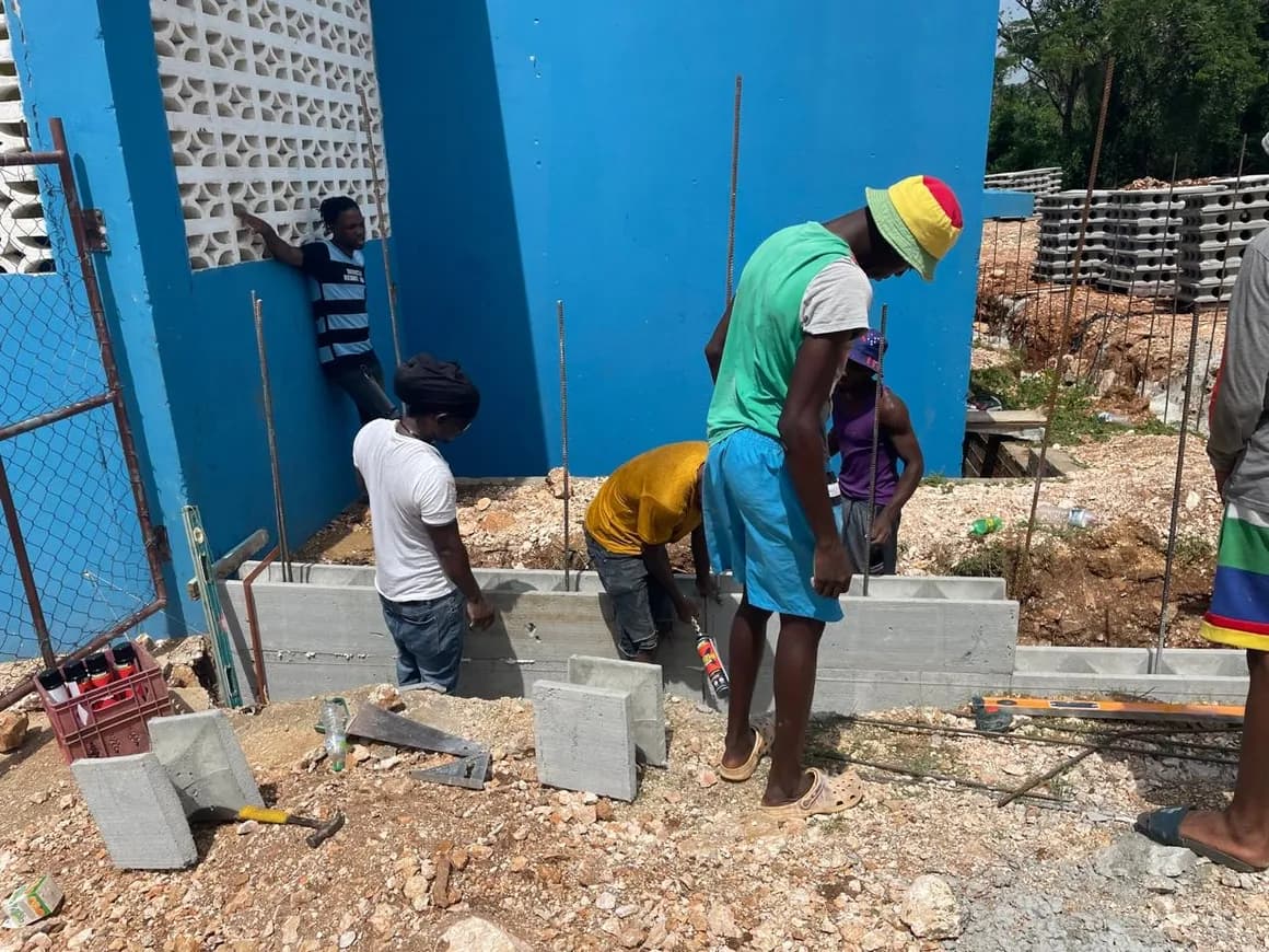 Community volunteers working on the wall construction