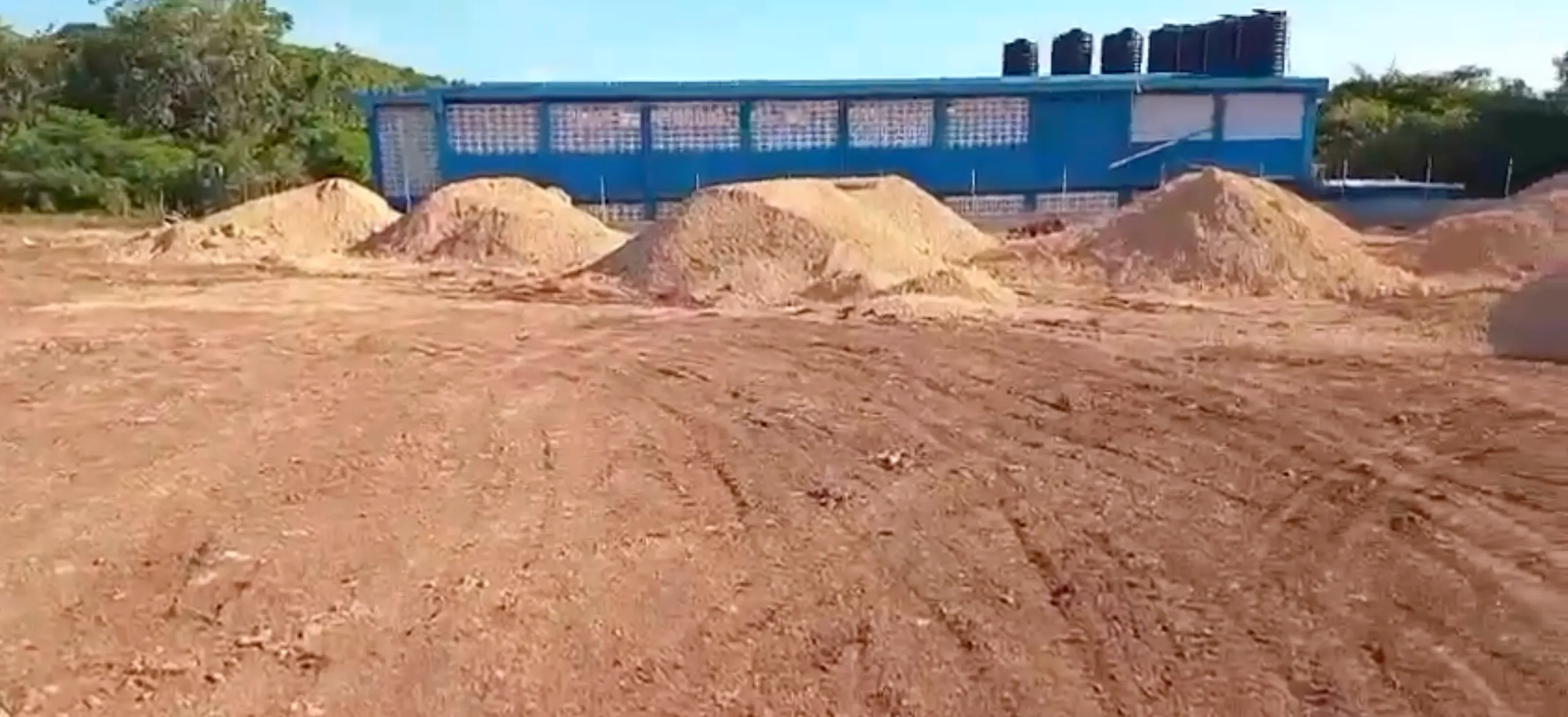 Field area being prepared with soil piles